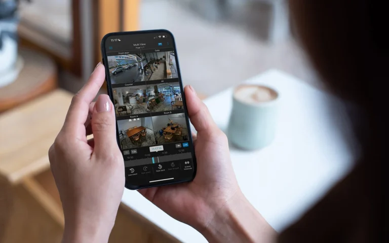 Synology DS cam app on a phone showing six Surveillance Station live feeds and the playback timeline